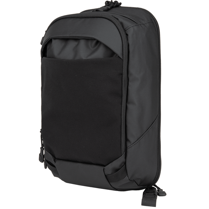The Vertx Urban Ghost Sling by Vertx is a stylish black backpack with a smooth finish, complemented by a front pocket, zipper closures, and adjustable shoulder straps. Its contemporary, minimalist design includes a concealed carry compartment, making it perfect for various uses.