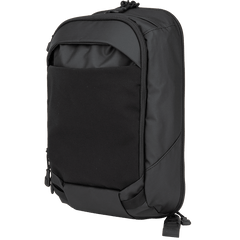 The Vertx Urban Ghost Sling by Vertx is a stylish black backpack with a smooth finish, complemented by a front pocket, zipper closures, and adjustable shoulder straps. Its contemporary, minimalist design includes a concealed carry compartment, making it perfect for various uses.