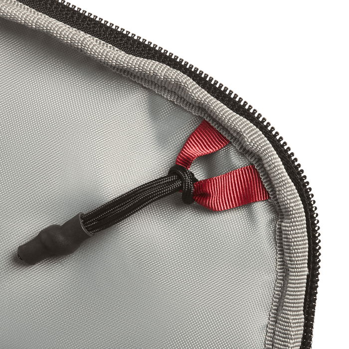 Close-up of the Vertx Everyday Fanny Pack 2.1 in gray, featuring a black zipper and a red ribbon loop attached to a black elastic cord with a rubber end, secured at the corner of the ballistic-panel compatible case.