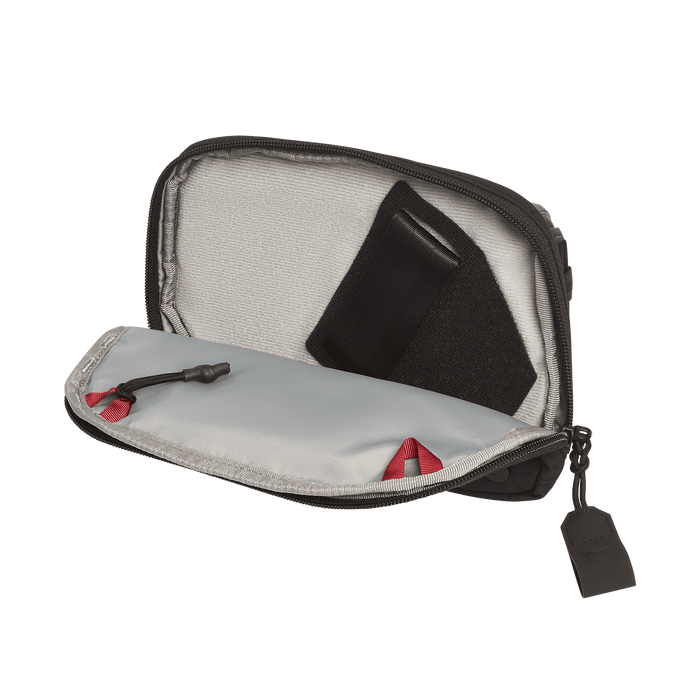 The Vertx Everyday Fanny Pack 2.1 is a compact EDC waist pack with a light gray interior, black zipper with red accent, and ballistic-panel compatibility. Shown open with a black fabric item stored inside.