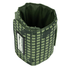 The Bulletproof Can Cooler - Limited Edition 2026 by Premier Body Armor is a green fabric pouch with a Desert Night Camo grid, standing upright and open at the top, featuring a rectangular patch with text on one side.