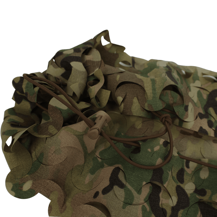 The OPE Gear Backpack Scrim - Camouflage Pack Cover features durable Cordura nylon with a unique camo pattern, brown adjustable drawstring, and plastic toggle—ideal for protecting your pack or enhancing concealment.